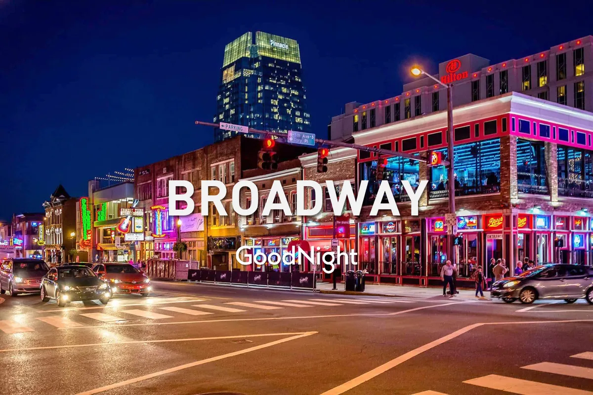 A dynamic city street scene at night featuring glowing neon signs, bustling restaurants and bars, and groups of people walking and enjoying the lively atmosphere. The energetic vibe captures Nashville’s famous nightlife and the excitement of exploring the city after dark.
